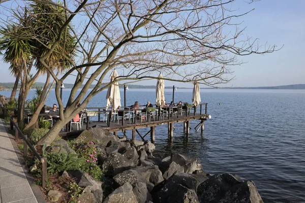 Italy, Lazio, Bracciano lake, Trevignano (Rome); 6 April 2016, people relaxing on a wooden pier by the lake - EDITORIAL — Stock Photo, Image