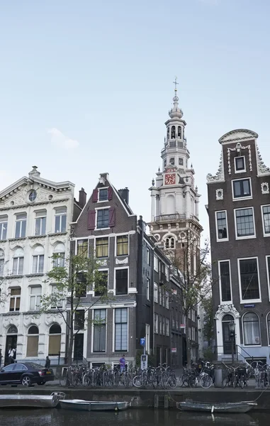 Holland, Amsterdam; 9 October 2011, the facade of old stone houses and a church downtown - EDITORIAL — Stock Photo, Image