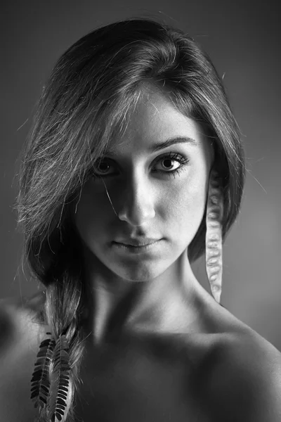 Studio portrait of a beautiful girl wearing a seed for earring — Stock Photo, Image