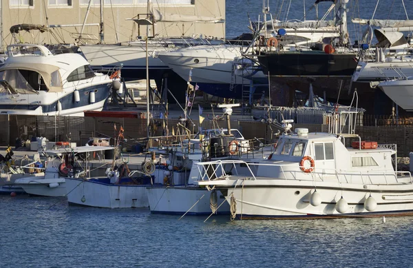 Italy, Sicily, Mediterranean sea, Marina di Ragusa; 21 May 2016, wooden fishing boats and luxury yachts ashore in the port - EDITORIAL — Stock Photo, Image