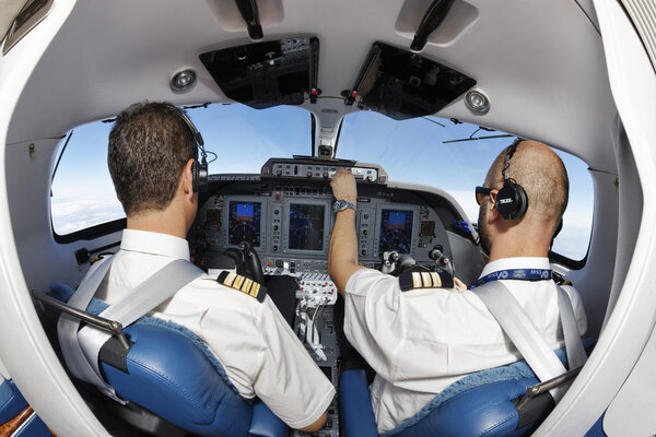 Italy; 26 July 2010, pilots in an flying airplane's cockpit - EDITORIAL