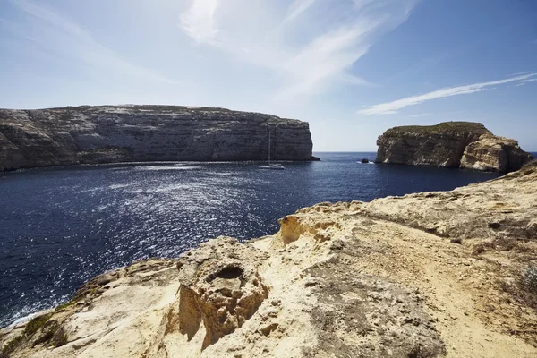 Malta Island, Gozo, view of sailing boats in the Dweira Lagoon and the rocky coastline near the Azure Window Rock