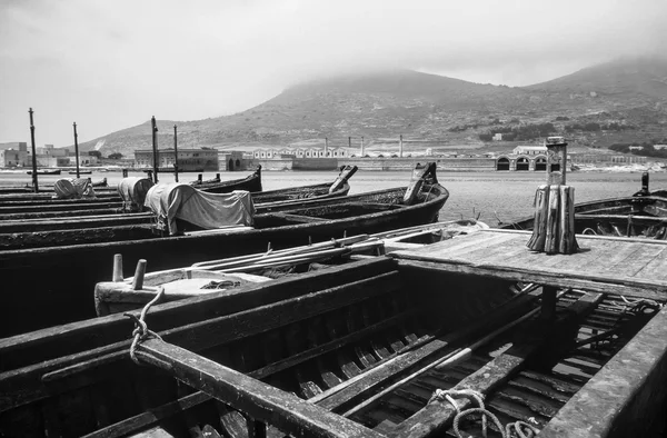 Italy, Sicily, Favignana Island, tuna fishing wooden boats in the port (the tuna fishing factory in the background) - FILM SCAN — Stock Photo, Image