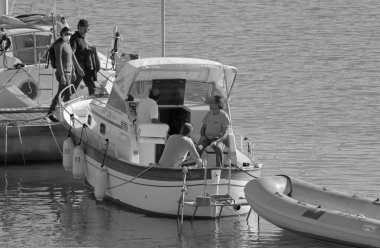 İtalya, Sicilya, Akdeniz, Marina di Ragusa (Ragusa Eyaleti); 21 Ekim 2020, limanda lüks bir yatta insanlar - EDITORIAL