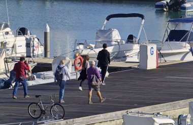 İtalya, Sicilya, Akdeniz, Marina di Ragusa (Ragusa Eyaleti); 2 Ocak 2021, limandaki insanlar, motorlu tekneler ve lüks yatlar - EDITORIAL