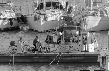 Italy, Sicily, Mediterranean sea, Marina di Ragusa (Ragusa Province); 4 January 2021, people and sailing boats in the port - EDITORIAL