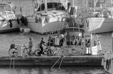Italy, Sicily, Mediterranean sea, Marina di Ragusa (Ragusa Province); 4 January 2021, people and sailing boats in the port - EDITORIAL