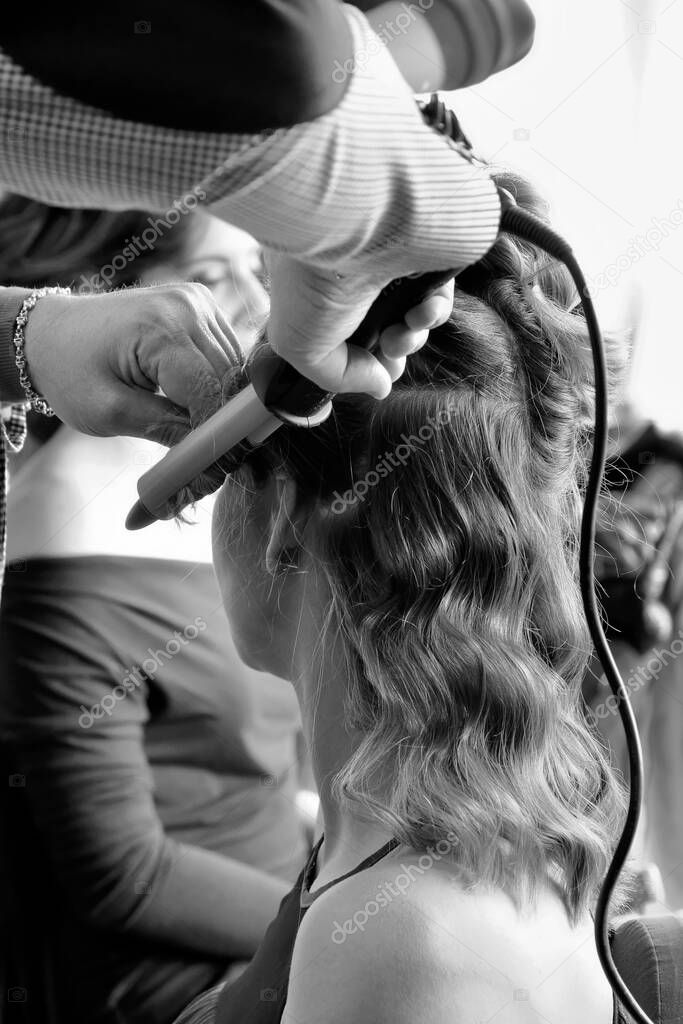 Italy, Sicily, Palermo; hairstylist combing a young girl 