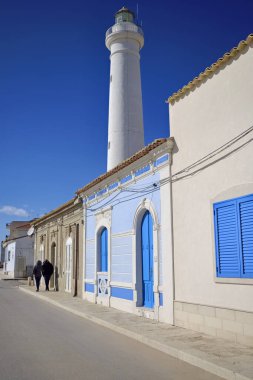 İtalya, Sicilya, Akdeniz, Punta Secca (Ragusa Eyaleti), insanlar, deniz kenarında ve deniz fenerinde eski bir Sicilya barok evinin cephesi