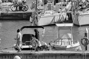 Italy, Sicily, Mediterranean sea, Marina di Ragusa (Ragusa Province); 26 March 2021, people, motor boats and luxury yachts in the port - EDITORIAL