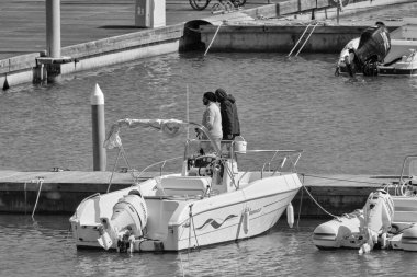 Italy, Sicily, Mediterranean sea, Marina di Ragusa (Ragusa Province); 26 March 2021, people and motor boats in the port - EDITORIAL