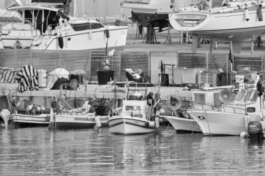 İtalya, Sicilya, Marina di Ragusa (Ragusa Eyaleti), 24 Nisan 2021, limanda yerel balıkçı tekneleri ve lüks yatlar - EDITORIAL