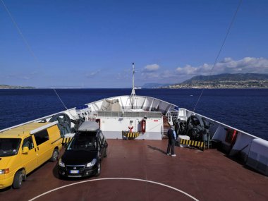İtalya, Sicilya kanalı, soldaki Sicilya sahili manzarası ve sağdaki Calabria kıyısı, Sicilya 'yı İtalya yarımadasına bağlayan birçok feribottan birinin üzerinde.