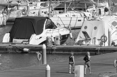 İtalya, Sicilya, Akdeniz, Marina di Ragusa (Ragusa Eyaleti); 16 Mayıs 2021, limandaki insanlar ve lüks yatlar - EDITORIAL