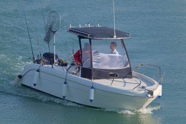 İtalya, Sicilya, Akdeniz, Marina di Ragusa (Ragusa Eyaleti); 13 Haziran 2021, limandaki bir motorlu teknede balıkçı - EDITORIAL