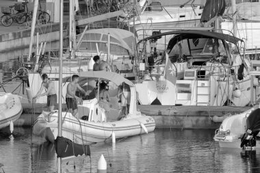 İtalya, Sicilya, Akdeniz, Marina di Ragusa (Ragusa Eyaleti); 28 Haziran 2021, limandaki kauçuk tekne ve lüks yatlarda yaşayan insanlar - EDITORIAL