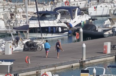 Italy, Sicily, Mediterranean sea, Marina di Ragusa (Ragusa Province); 27 July 2021, people, motor boats and luxury yachts in the port - EDITORIAL