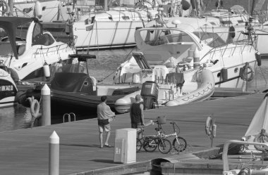 Italy, Sicily, Mediterranean sea, Marina di Ragusa (Ragusa Province); 27 July 2021, people, motor boats and luxury yachts in the port - EDITORIAL