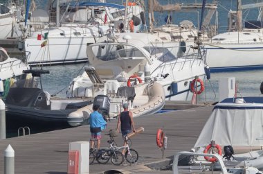 Italy, Sicily, Mediterranean sea, Marina di Ragusa (Ragusa Province); 27 July 2021, people, motor boats and luxury yachts in the port - EDITORIAL