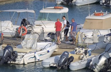Italy, Sicily, Mediterranean sea, Marina di Ragusa (Ragusa Province); 27 July 2021, people, motor boats and luxury yachts in the port - EDITORIAL