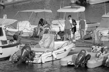 Italy, Sicily, Mediterranean sea, Marina di Ragusa (Ragusa Province); 27 July 2021, people, motor boats and luxury yachts in the port - EDITORIAL