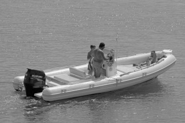 İtalya, Sicilya, Akdeniz, Marina di Ragusa (Ragusa Eyaleti); 18 Eylül 2021, limandaki kauçuk bir teknede insanlar - EDITORIAL