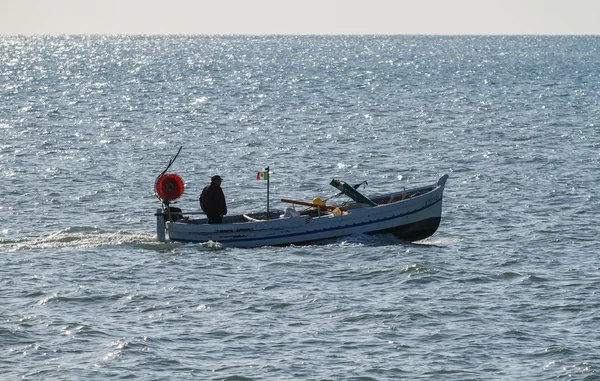 Pescador en su barco de pesca de madera — Foto de Stock
