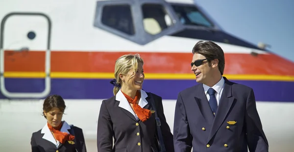 Flight assistants near an airplane — Stock Photo, Image