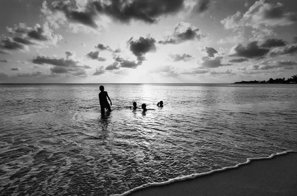 해질녘 바다 물에서 재생 하는 아이 — 스톡 사진
