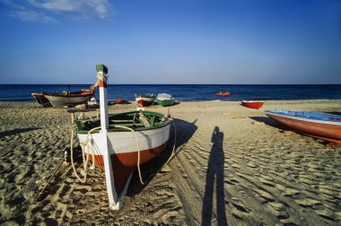 Fishing boats on the beach clipart
