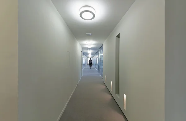 Uomo che cammina in un corridoio dell'edificio aziendale — Foto Stock
