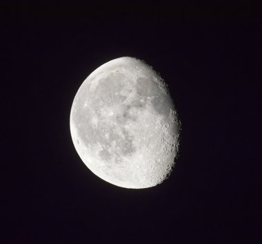 Waning moon in night sky clipart