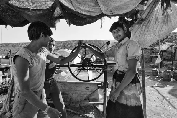 indian people working in a fabrics factory