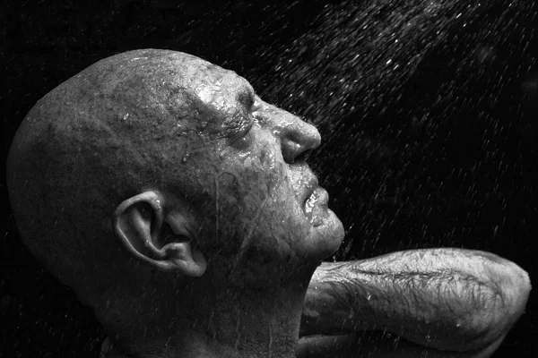 Portrait of a bald old man showering — Stock Photo, Image