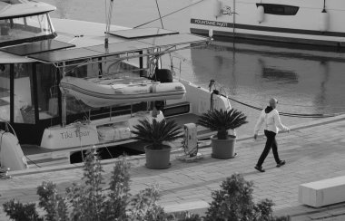 Italy, Sicily, Mediterranean sea, Marina di Ragusa (Ragusa Province); 11 November 2025, man and catamaran sailing boats in the port - EDITORIAL