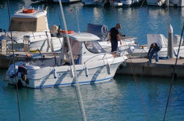 Italy, Sicily, Mediterranean Sea, Marina di Ragusa (Ragusa Province); 13 November 2025, sport fishermen on a motor boat in the port - EDITORIAL