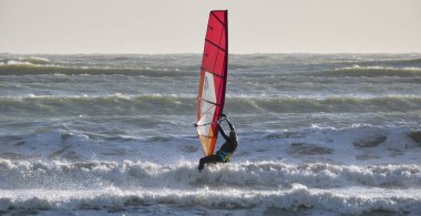 İtalya, Sicilya, Akdeniz, Marina di Ragusa (Ragusa ili); 7 Aralık 2021, denizde sörfçü - EDITORIAL