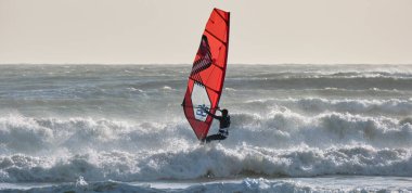 İtalya, Sicilya, Akdeniz, Marina di Ragusa (Ragusa ili); 7 Aralık 2021, denizde sörfçü - EDITORIAL