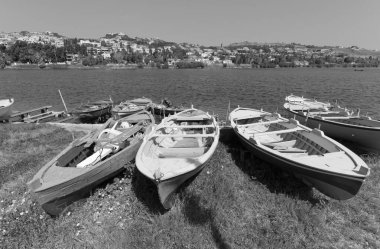 İtalya, Sicilya, Messina, Ganzirri kasabası, tahta balıkçı tekneleri ve Ganzirri gölünde bir balıkçı.