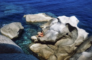 France, Southern Corsica, Tyrrhenian Sea, Ajaccio, girl on the rocky coastline  - FILM SCAN clipart