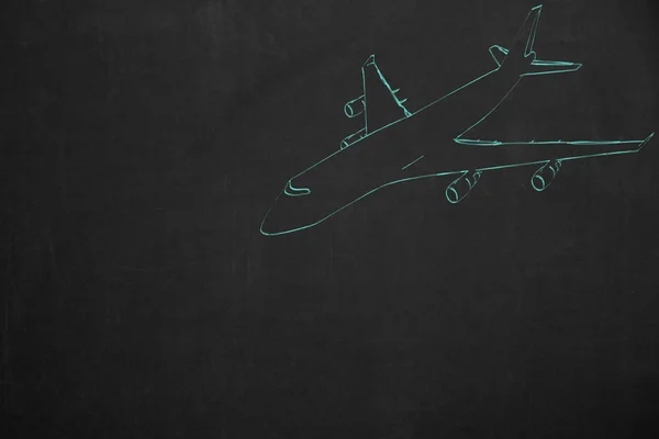 黑暗的黑板上用绿松石粉笔绘制的飞机 — 图库照片