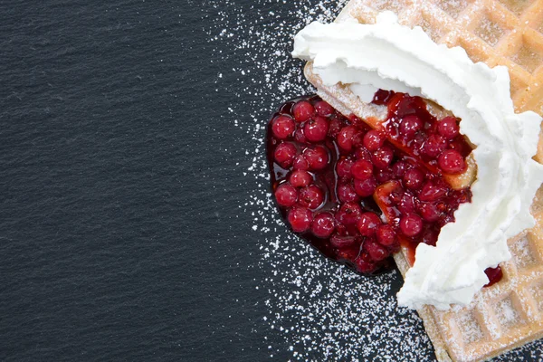 A top view from waffles with cream and cranberries on a dark sla — Stock Photo, Image
