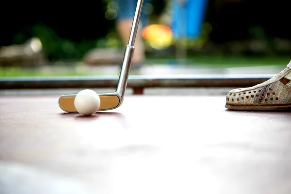 Vista de perto de um jogador profissional minigolfe batendo uma bola branca — Fotografia de Stock