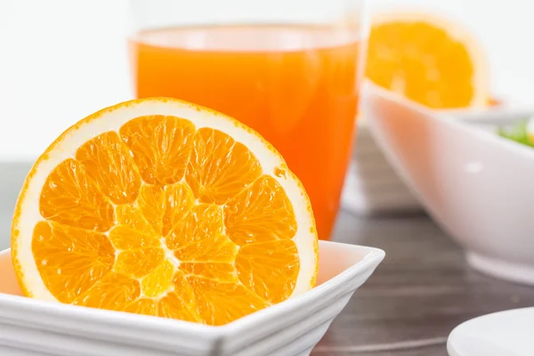 Half cutted orange fruit in a bowl — Stock Photo, Image