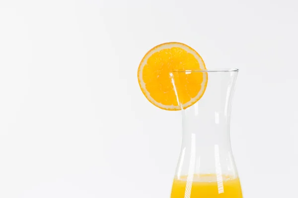 Half of a carafe with fresh orange juice, isolated on white — Stock Photo, Image