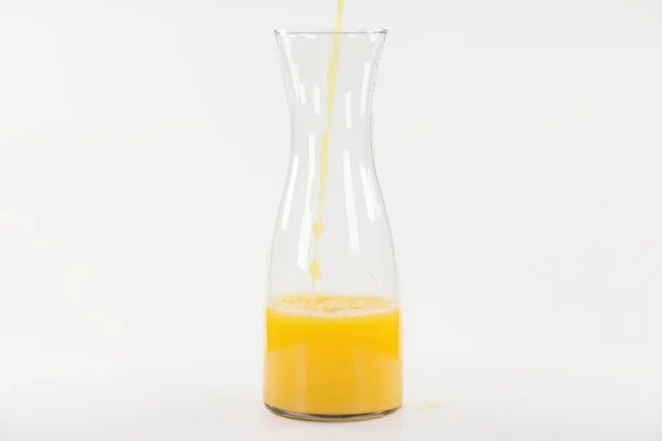 Big carafe of orange juice, isolated on white — Stock Photo, Image