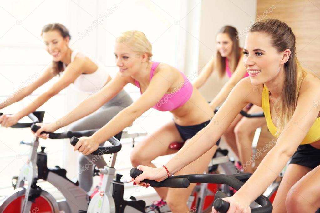 Sporty women on spinning class