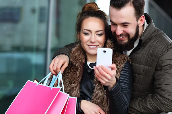 Giovane coppia shopping con smartphone — Foto Stock