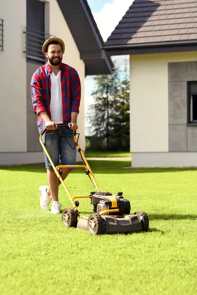 Homme tondre l'herbe — Photo