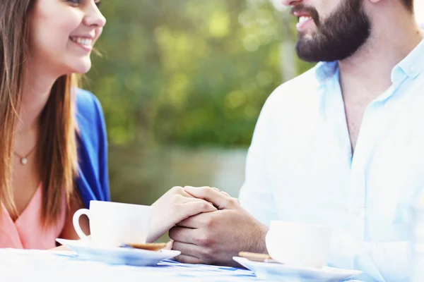 Hands of romantic couple in cafe — Stock Photo, Image